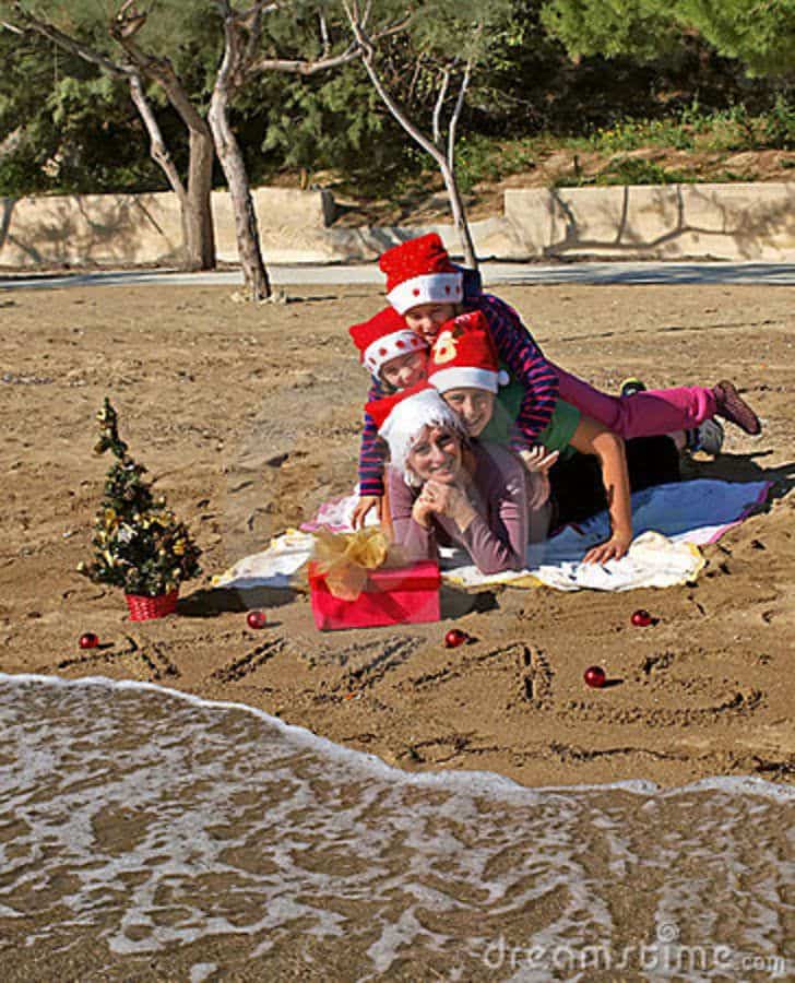Christmas Family Laying On Sand Beach Stock Photos